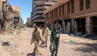 Fighters loyal to the army patrol a market area in Khartoum on March 24, 2025. (Photo by AFP)
