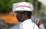 A traffic policeman uses an air-conditioned helmet to get respite from the heat while working at a road junction on a hot summer day in Chennai on April 8, 2025. Photo by R.Satish BABU / AFP