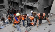 Palestinian rescuers work at the site of an Israeli strike on a residential area in Gaza City's Shujaiyya neighbourhood, on April 9, 2025. (Photo by Omar Al-Qattaa / AFP)