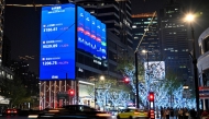 A screen showing the Shanghai composite index (top), Shenzhen component index (C) and Beijing stock exchange 50 index (bottom) is seen in Jing'an district in Shanghai on April 9, 2025. Photo by Hector RETAMAL / AFP