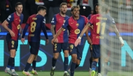Barcelona's Spanish forward #19 Lamine Yamal and teammates celebrate Barcelona's Polish forward #09 Robert Lewandowski's third goal during the UEFA Champions League Quarter final First Leg football match between FC Barcelona and BVB Borussia Dortmund at the Estadi Olimpic Lluis Companys in Barcelona on April 9, 2025. (Photo by LLUIS GENE / AFP)

