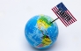 This photograph taken in Paris on April 8, 2025 shows a globe with a USA flag with the inscription 