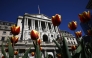 Tulips are pictured in front of the Bank of England, in central London, on April 7, 2025. Photo by BENJAMIN CREMEL / AFP.