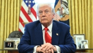 US President Donald Trump looks on after signing an executive order in the Oval Office of the White House on April 9, 2025 in Washington, DC. (Photo by Saul Loeb / AFP)
