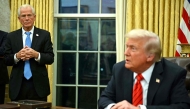 US President Donald Trump speaks to the press, alongside counselor to US President Donald Trump, Peter Navarro (L), after signing an executive order in the Oval Office of the White House in Washington, DC, on February 10, 2025. Photo by ANDREW CABALLERO-REYNOLDS / AFP