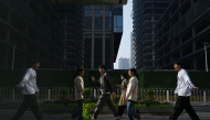 Office workers walk to their offices in Beijing's central business district on April 10, 2025. Photo by GREG BAKER / AFP