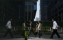Office workers walk to their offices in Beijing's central business district on April 10, 2025. Photo by GREG BAKER / AFP