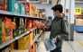 A man buys products in a supermarket in Beijing on April 10, 2025. (Photo by Pedro PARDO / AFP)
