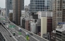 This general view shows an elevated expressway alongside highrise buildings in downtown Osaka on April 10, 2025. (Photo by Richard A. Brooks / AFP)
