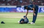 Gujarat Titans' Washington Sundar (R) checks on his teammate Glenn Phillips during the Indian Premier League (IPL) Twenty20 cricket match in Hyderabad on April 6, 2025. (Photo by Noah Seelam / AFP) 