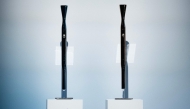 A picture shows the torches for the Milano Cortina 2026 winter olympic (L) and paralympic (R) games during the unveiling ceremony in Milan on April 14, 2025. (Photo by MARCO BERTORELLO / AFP)