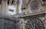 (Files) Workers operate on scaffoldings during reconstruction works around the wooden structure of the Notre-Dame de Paris Cathedral, in Paris on July 4, 2024. (Photo by Joel Saget / AFP)