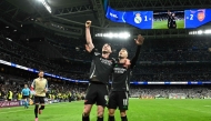 Arsenal's Brazilian midfielder #11 Gabriel Martinelli celebrates with Arsenal's English midfielder #41 Declan Rice scoring his team's second goal during the UEFA Champions League quarter final second leg football match between Real Madrid CF and Arsenal at Santiago Bernabeu Stadium in Madrid on April 16, 2025. (Photo by JAVIER SORIANO / AFP)
