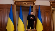 Ukraine's President Volodymyr Zelensky takes notes during a press conference in Kyiv on April 17, 2025, amid the Russian invasion of Ukraine. (Photo by Tetiana Dzhafarova / AFP)