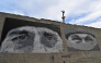 This photograph shows graffitis depicting fallen Ukrainian servicemen, painted by street artists at the Independence Square in Kyiv on April 19, 2025, amid the Russian invasion of Ukraine. Russian President Vladimir Putin on April 19 announced a surprise Easter truce in the conflict in Ukraine to last until midnight on April 20. (Photo by Sergei SUPINSKY / AFP)