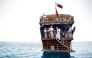 Participants aboard a traditional dhow boat during the hand-line fishing competition of the Senyar Festival off of Sealine south of Doha on April 21, 2025. (Photo by Karim Jaafar / AFP)