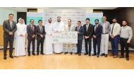 LuLu Hypermarket Qatar officials handing over the donation cheque.