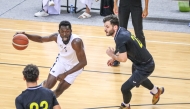 Al Sadd's Babacar Dieng dribbles past Qatar SC players.