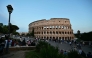Visitors walk past the Colosseum, a day after the Pope's death, in Rome on April 22, 2025. (Photo by Andrej ISAKOVIC / AFP)
