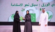 Minister of Education and Higher Education H E Lolwah bint Rashid Al Khater honouring a winner. 