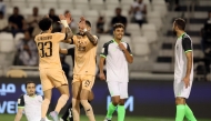 Al Sadd’s Claudinho and Giovani celebrate as Al Ahli’s Matej Mitrovic (left) reacts after scoring an own goal during the first semi-final.