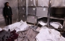 A Palestinian man stand over covered bodies, killed in an Israeli strike on a school-turned-shelter, at the morgue of the Al-Shifa hospital in Gaza City on April 23, 2025. Photo by Omar AL-QATTAA / AFP