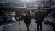 An elderly woman walks in the Dongmyo Flea Market in Seoul on April 15, 2025. (Photo by ANTHONY WALLACE / AFP)
