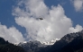 An Indian military helicopter is seen in flight as viewed from Baisaran, a day after tourist attack in Pahalgam, about 90 kms (55 miles) from Srinagar on April 23, 2025. (Photo by TAUSEEF MUSTAFA / AFP)
