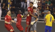 Al Duhail players celebrate with goalkeeper Bautista Burke after the win. 