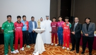 Captains of the participating teams pose for a group picture with officials.