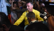 (FILES) Former Brazilian President Jair Bolsonaro is pictured before boarding an ambulance as he leaves Rio Grande Hospital in Natal, Rio Grande do Norte state, Brazil, on April 12, 2025. (Photo by Jose ALDENIR / AFP)
