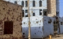File: A bullet-riddled buildings in Khartoum's twin-city Omdurman on March 20, 2025. (Photo by Ebrahim Hamid / AFP)