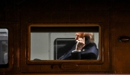 US President Donald Trump uses a cellphone aboard Marine One before it departs Leesburg Executive Airport in Leesburg, Virginia, on April 24, 2025. Photo by Alex WROBLEWSKI / AFP.
