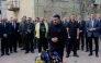 Ukraine's President Volodymyr Zelensky talks to the press as diplomats stands behind him near a destroyed residential building following a Russian missile attack in Kyiv on April 25, 2025, amid the Russian invasion of Ukraine. (Photo by Tetiana DZHAFAROVA / AFP)
