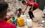 A boy fills up containers with water from the remaining water still left in underground pipes, in Beit Lahia in the northern Gaza Strip on April 24, 2025. Photo by Bashar Taleb/ AFP