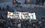 Attendees hold a banner reading 