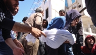 People carry the body of a member of the Al-Khour family in front of the Al-Shifa hospital after their house was hit by an Israeli strike in Gaza City's Sabra neighbourhood on April 26, 2025. (Photo by Omar AL-QATTAA / AFP)
