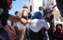 People carry the body of a member of the Al-Khour family in front of the Al-Shifa hospital after their house was hit by an Israeli strike in Gaza City's Sabra neighbourhood on April 26, 2025. (Photo by Omar AL-QATTAA / AFP)
