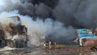 Firefighters and rescuers work at the scene of an explosion that took place a day earlier at the Shahid Rajaee port dock, southwest of Bandar Abbas in the Iranian province of Hormozgan, on April 27, 2025.  (Photo by Meysam Mirsadeh / Tasnim News / AFP)