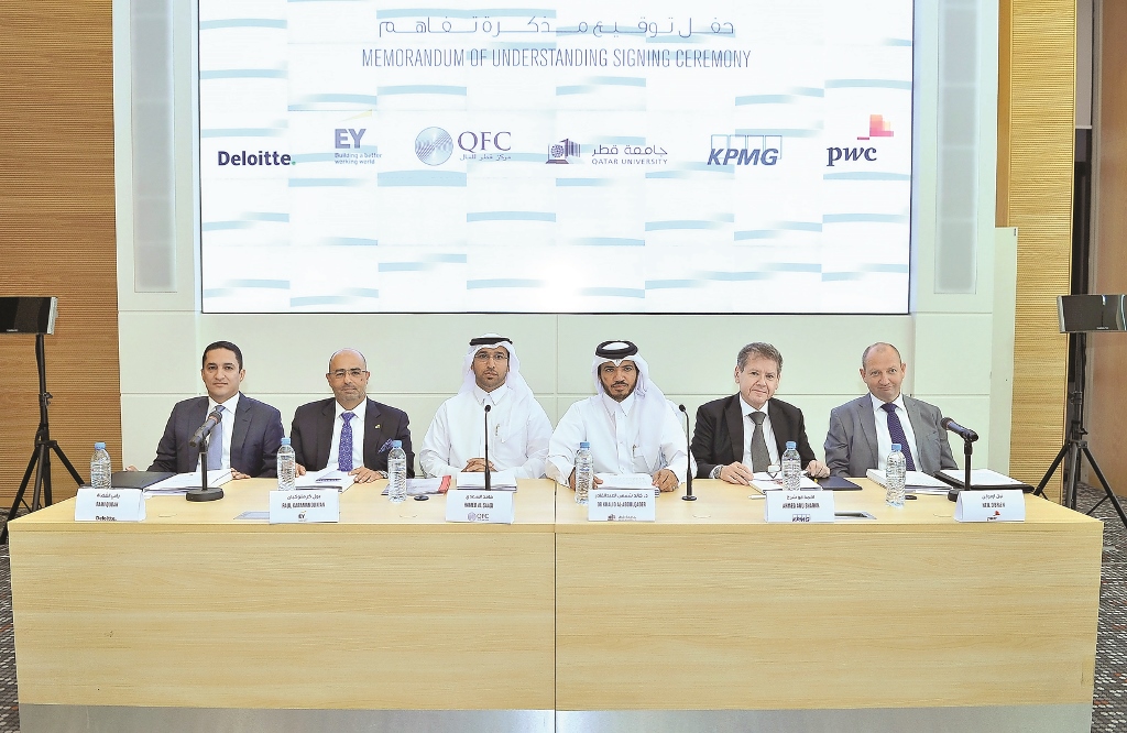 Hamed Al Saadi (centre), Chief Financial and Tax Officer at QFC Authority and Dr Khalid Shams Al Abdulqader, Dean, QU-CBE, with representatives of accounting firms during the MoU signing ceremony.  Pic: Baher Amin / The Peninsula