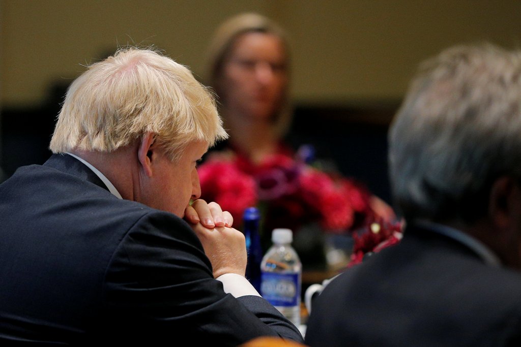 United Kingdom Foreign Secretary Boris Johnson (L) and European Union High Representative Federica Mogherini (rear) listen as United States Secretary of State John Kerry speaks during a meeting of foreign ministers from Germany, the UK, France, Italy and 