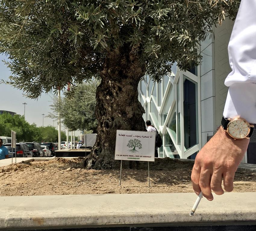 Jaidah Square officials have posted signs around the olive trees planted in front of their building on Airport Road to caution smokers from extinguishing their cigarette buds there. Authorities have also placed ashtrays around the premises. 
Pic: Qassim