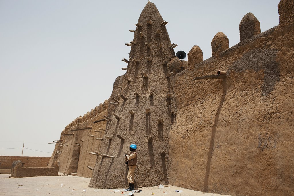 File photo of a UN peacekeeper from Burkina Faso guarding the Djinguereber mosque, built in the 14th century, during a visit by a UN delegation on election day in Timbuktu, Mali. Reuters/Joe Penney/Files