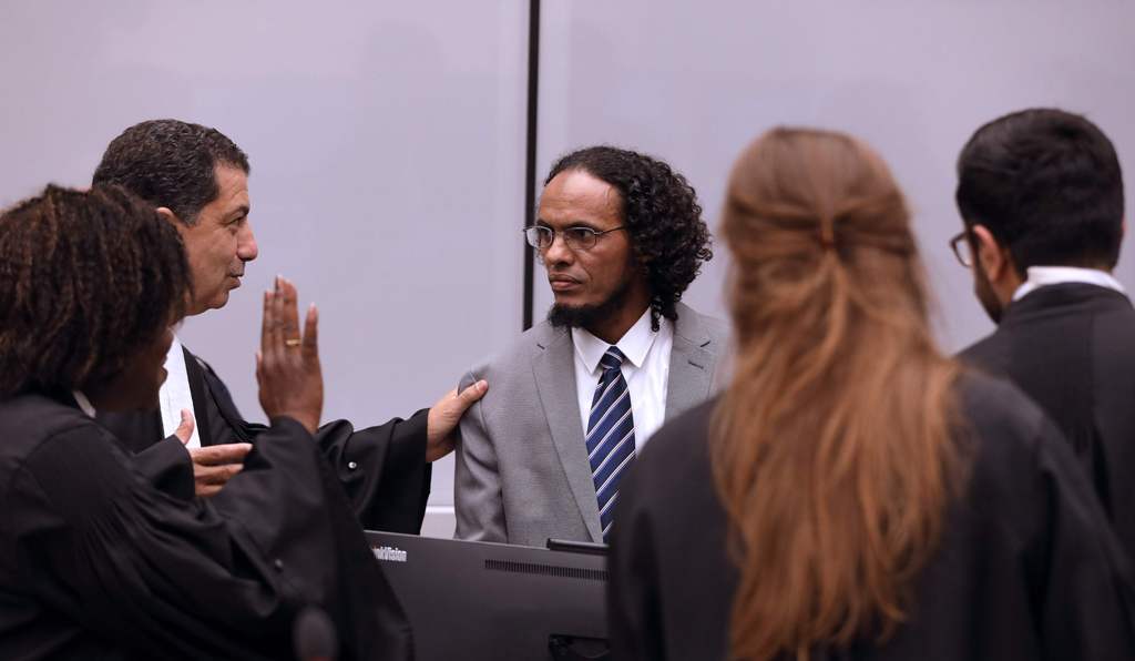 Malian jihadist Ahmad al-Faqi al-Mahdi (C) speaks with his lawyer Mohamed Aouini (L) at the International Criminal Court (ICC) in The Hague on September 27, 2016, during his sentencing for destroying Timbuktu's shrines. AFP / ANP / Bas Czerwinski