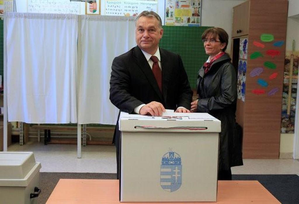 Hungary's Prime Minister Viktor Orban casts his ballot next to his wife Aniko Levai inside a polling station during a referendum on EU migrant quotas in Budapest, Hungary, October 2, 2016. (Bernadett Szabo / Reuters)