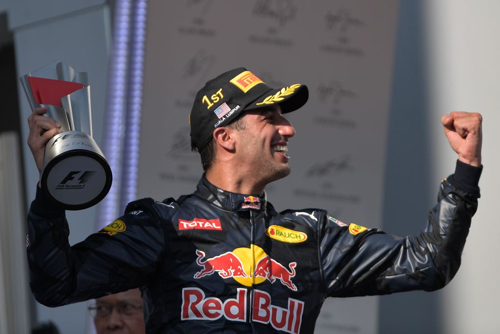 Red Bull Racing's Australian driver Daniel Ricciardo holds the trophy as he celebrates taking first place at the Formula One Malaysian Grand Prix in Sepang on October 2, 2016. (AFP / MOHD RASFAN)