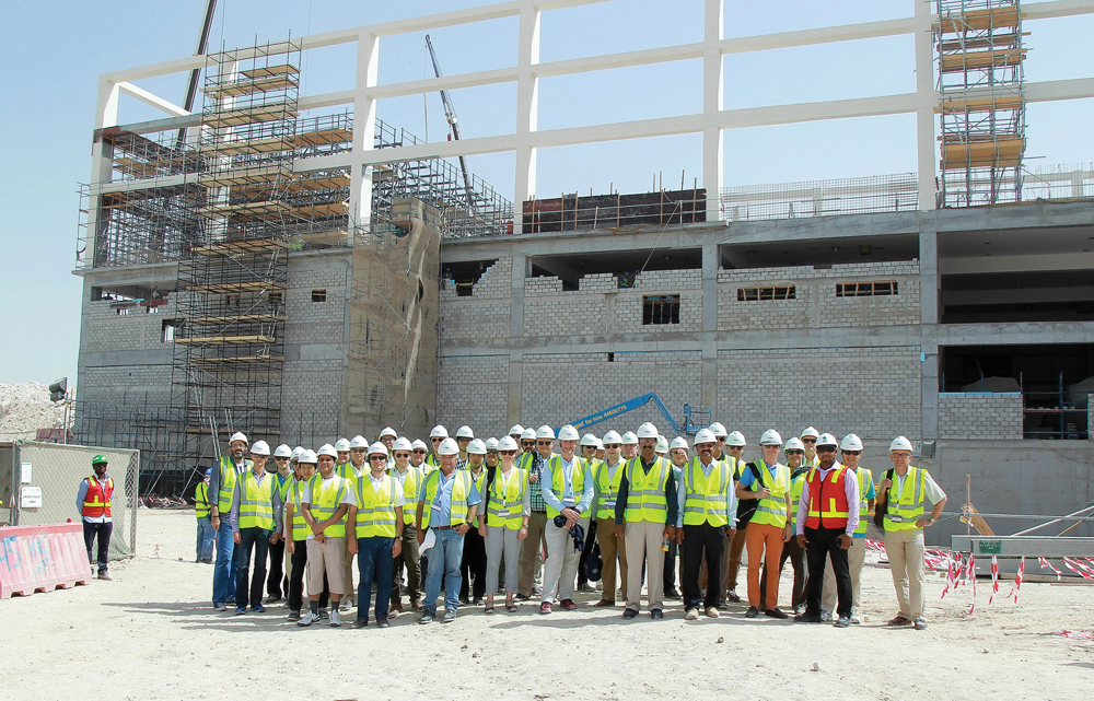 International Engineering Insurance Association delegates posing for a group picture at the construction site of the Khalifa International Stadium.