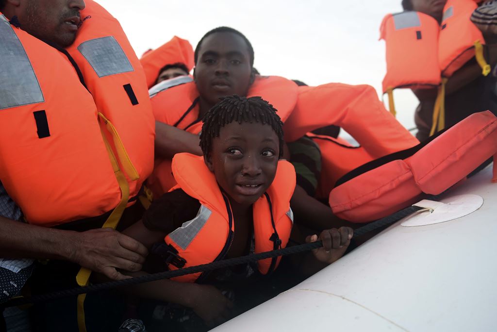 A child cries as migrants are being rescued by members of Proactiva Open Arms NGO in the Mediterranean Sea, some 12 nautical miles north of Libya, on October 4, 2016. AFP / ARIS MESSINIS