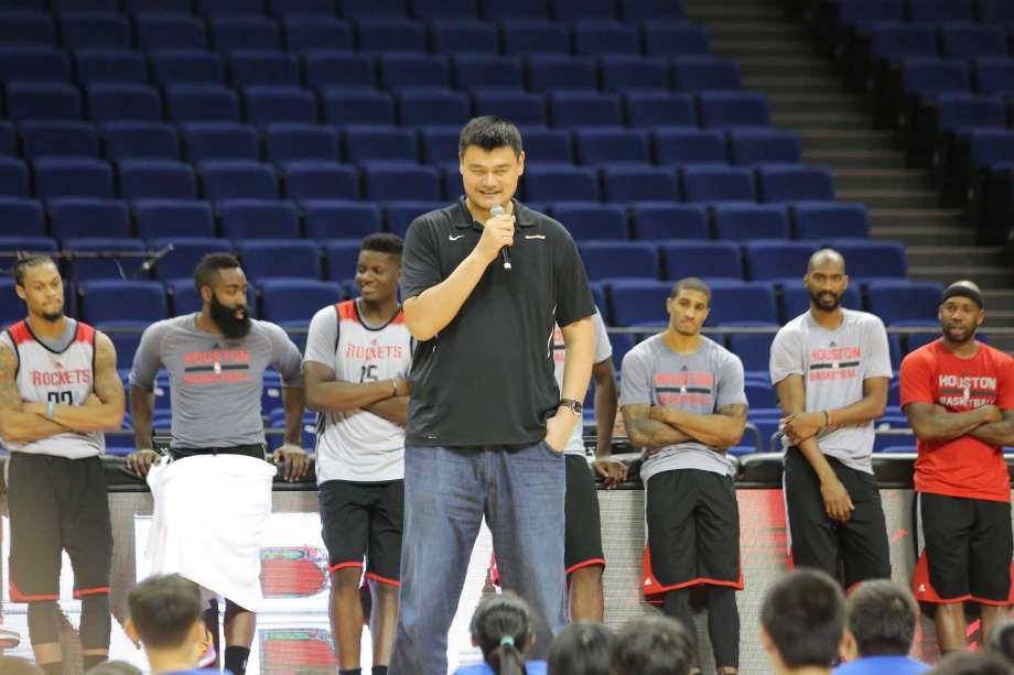 Retired Chinese basketball superstar Yao Ming, tallest, and players of Houston Rockets take part in a basketball camp event in Shanghai, China, 8 October 2016.