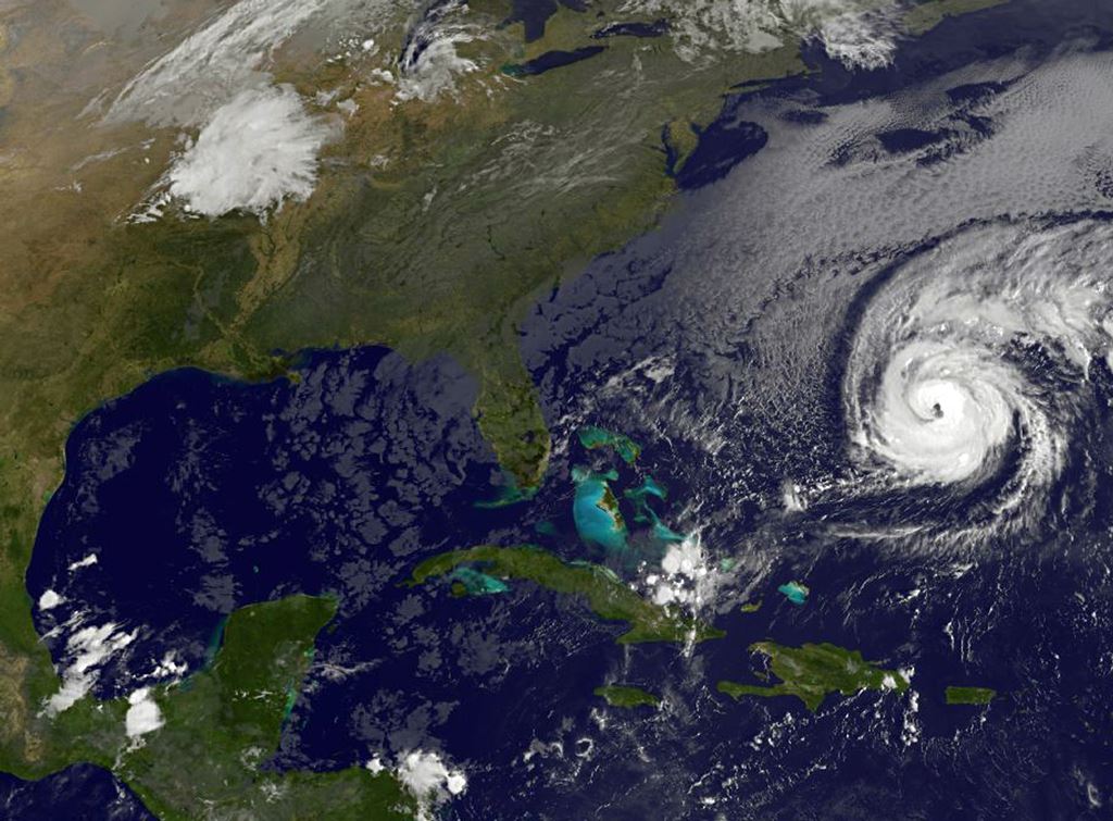 This NOAA-NASA Goes East project satellite image shows Hurricane Nicole (R) at 1137UTC on October 12, 2016. AFP PHOTO / NOAA-NASA GOES PROJECT 